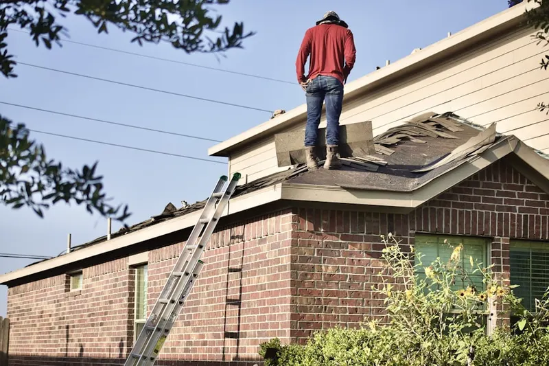 Professional roofer working on a residential roof in Downtown Everett